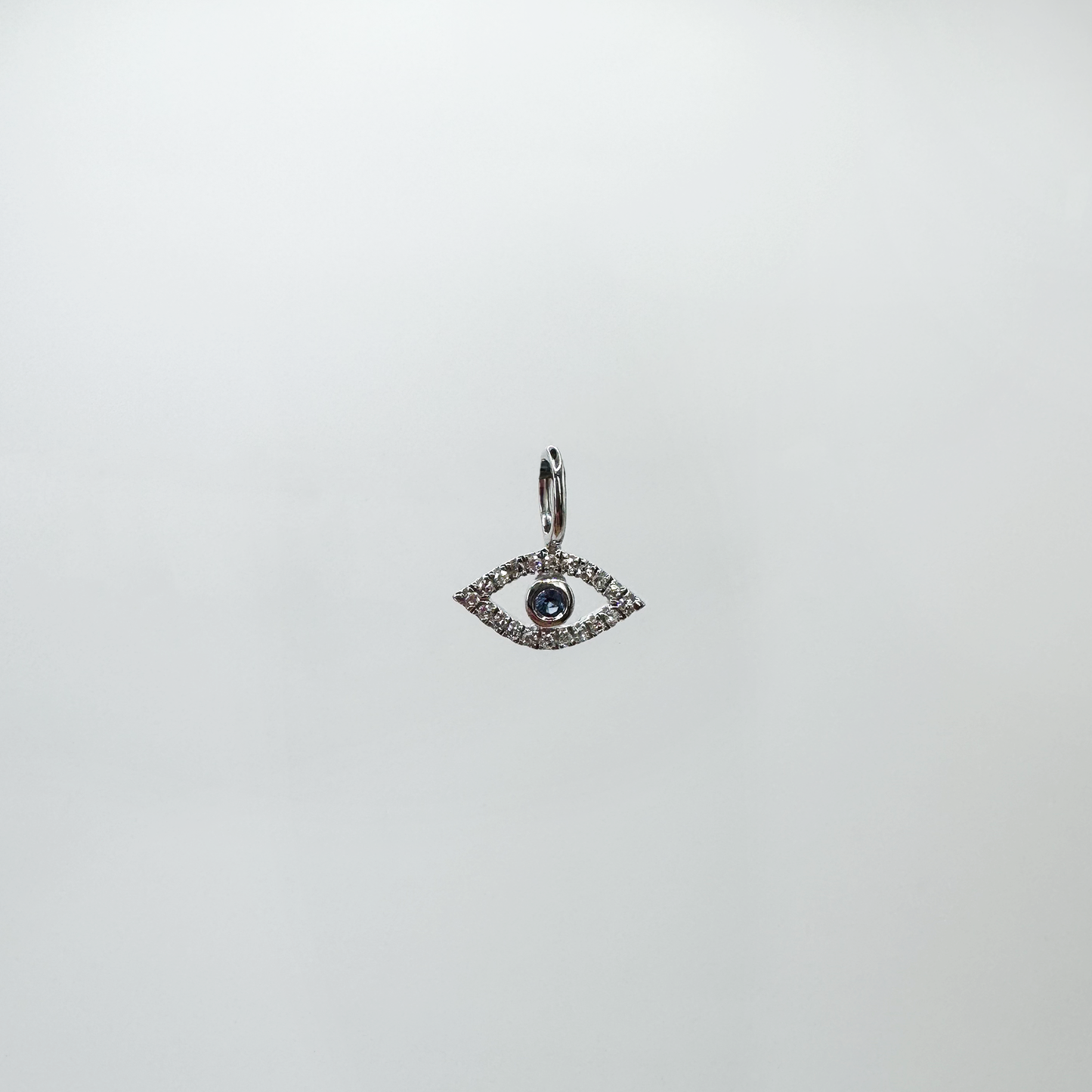 Charm mini evil eye diamantes y oro blanco.