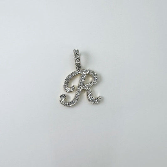 Dije letra "R" cursiva en oro y diamantes.