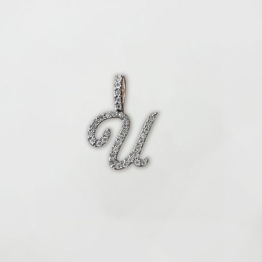 Dije letra "U" XL cursiva en oro y diamantes.