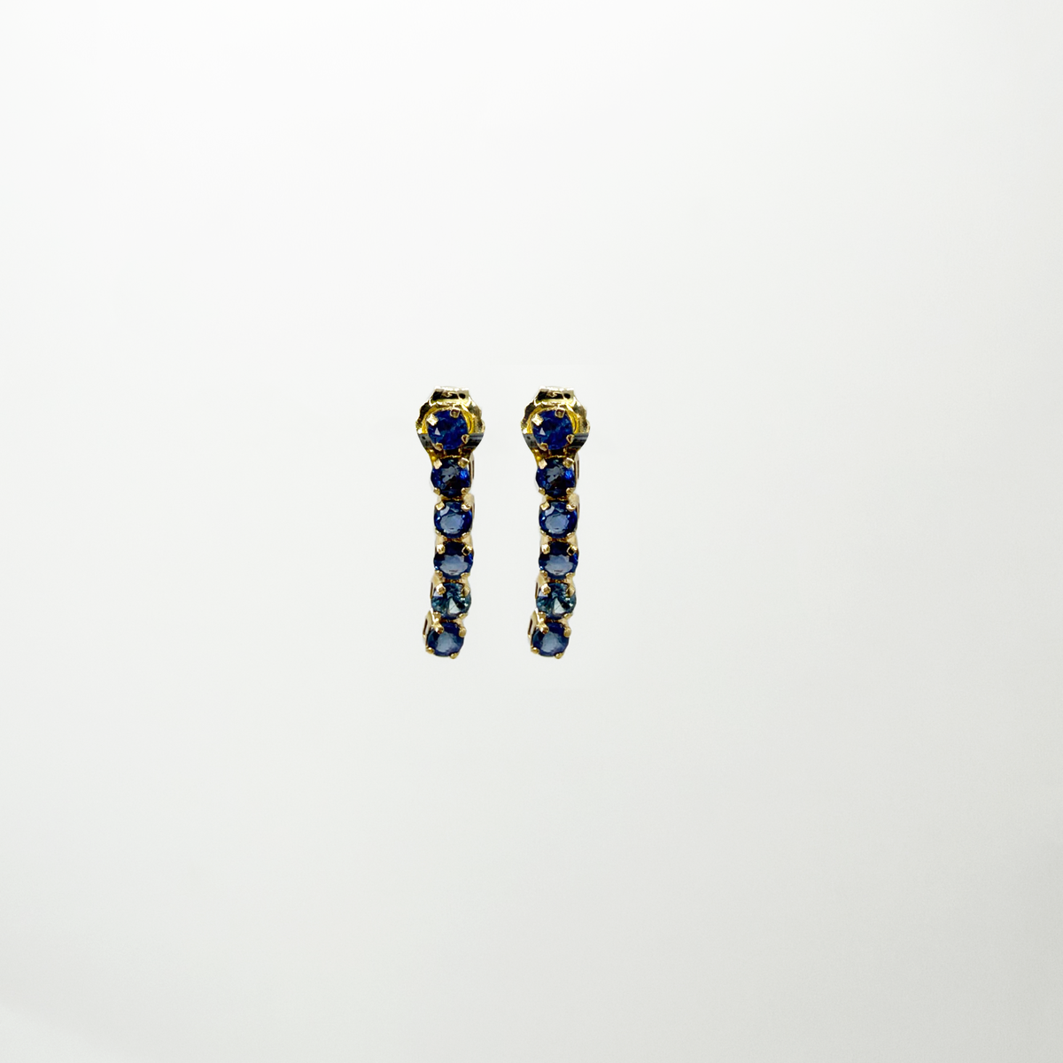 Aretes colgantes zafiros azules oro 14k.